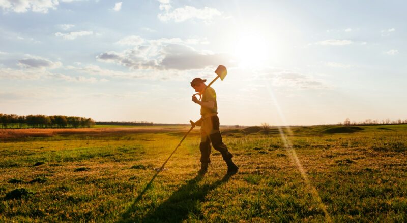 a man holding a ball and walking in a field