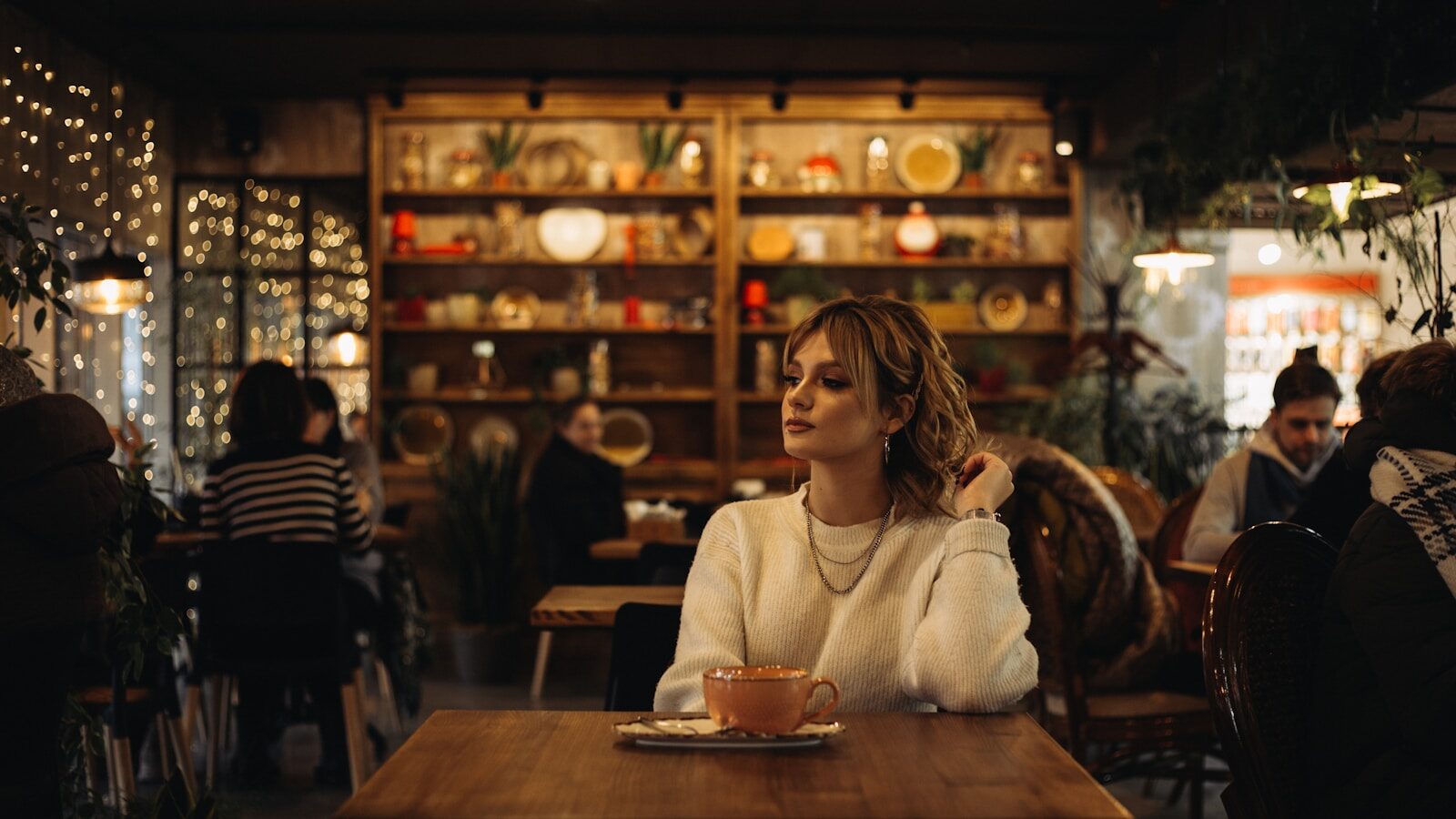woman in white sweater sitting on chair